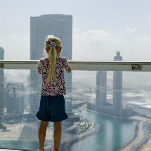 a woman looking at the burj khalifa