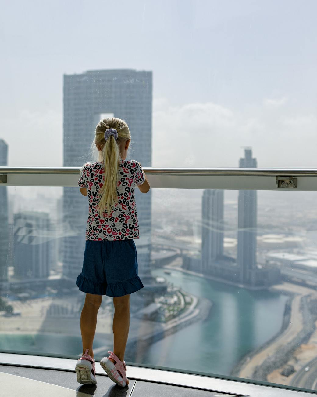 a woman looking at the burj khalifa